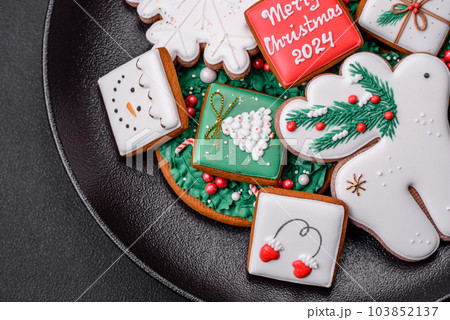 Delicious fresh colorful Christmas or New Year gingerbread cookies Delicious fresh colorful Christmas or New Year gingerbread cookies 103852137