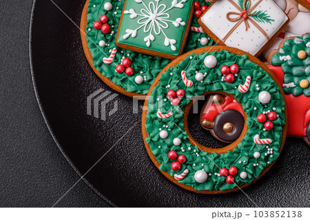 Delicious fresh colorful Christmas or New Year gingerbread cookies Delicious fresh colorful Christmas or New Year gingerbread cookies 103852138