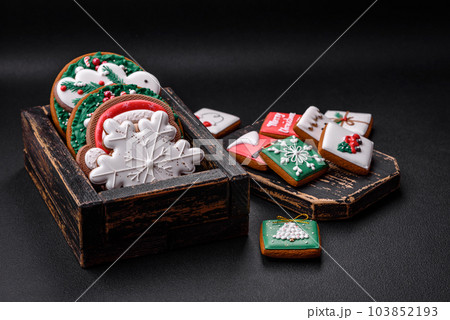 Delicious fresh colorful Christmas or New Year gingerbread cookies Delicious fresh colorful Christmas or New Year gingerbread cookies 103852193