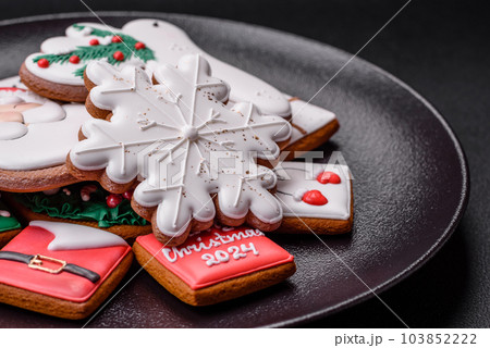 Delicious fresh colorful Christmas or New Year gingerbread cookies Delicious fresh colorful Christmas or New Year gingerbread cookies 103852222