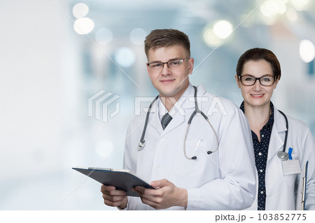 Doctors stand on a background. 103852775