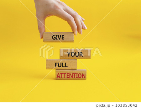 Give your full Attention symbol. Concept word Give your full Attention on wooden blocks. Beautiful yellow background. Businessman hand. Business and Give your full Attention concept. Copy space Give your full Attention symbol. Concept word Give your full Attention on wooden blocks. Beautiful yellow background. Businessman hand. Business and Give your full Attention concept. Copy space 103853042
