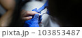 Manicurist doing hardware manicure to woman using special apparatus 103853487
