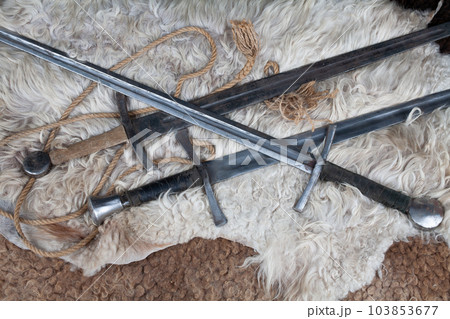 Medieval swords on sheep fur Medieval swords on sheep fur 103853677