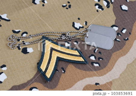 May 12, 2018. US ARMY Corporal rank patch and dog tags on desert camouflage uniform May 12, 2018. US ARMY Corporal rank patch and dog tags on desert camouflage uniform 103853691