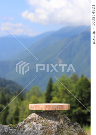 Slab Podium with a view of the mountains. The front showcase with a stage for products. A pedestal for the presentation of goods. Slab Podium with a view of the mountains. The front showcase with a stage for products. A pedestal for the presentation of goods. 103854921
