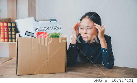 Female company employee stressed and fed up after quitting her job to look for a new job, fired or was fired by the employer 103857601