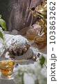 A light traditional still life, with a samovar, tea with lemon, a delicious cake with powdered sugar, and with white flowers. 103863262