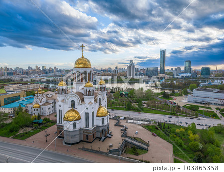 Summer Yekaterinburg and Temple on Blood in cloudy sunset. Aerial view of Yekaterinburg, Russia. Translation of the text on the temple 103865358