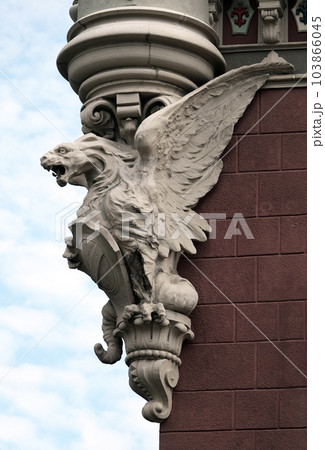 Kiev, Ukraine June 10, 2021: Sculpture of the Griffin - Lion in the body of an eagle with wings on the facade of a building in the center of Kiev 103866045