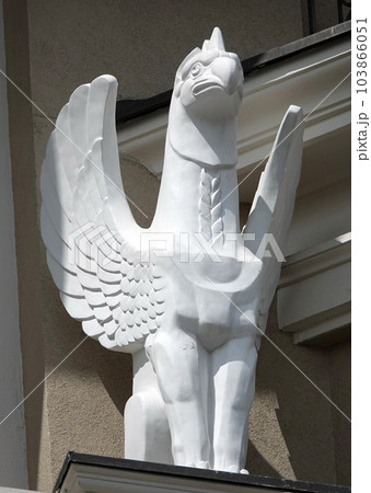 Kiev, Ukraine June 10, 2021: Sculpture of a Griffin eagle head in the body of a lion with wings on the facade of a building in the center of Kiev 103866051