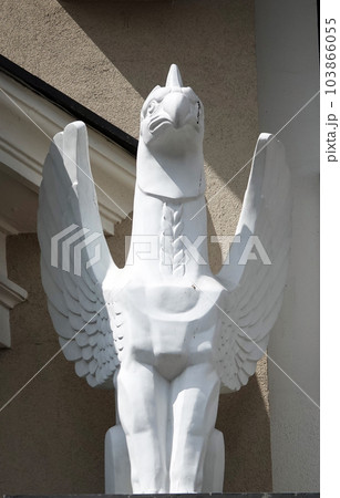 Kiev, Ukraine June 10, 2021: Sculpture of a Griffin eagle head in the body of a lion with wings on the facade of a building in the center of Kiev 103866055