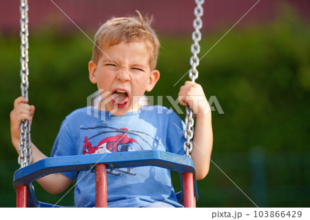 A capricious child on a swing. Parenting. Preschool education. A capricious child on a swing. Parenting. Preschool education. 103866429