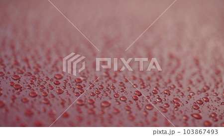 closeup shot of raindrops on red car with hydrophobic coating closeup shot of raindrops on red car with hydrophobic coating 103867493