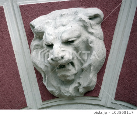 Kiev, Ukraine June 10, 2021: The facade of an ancient building decorated with a plaster lion in the center of Kiev Kiev, Ukraine June 10, 2021: The facade of an ancient building decorated with a plaster lion in the center of Kiev 103868117
