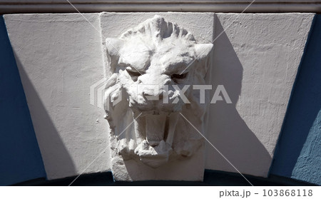 Kiev, Ukraine June 10, 2021: The facade of an ancient building decorated with a plaster lion in the center of Kiev 103868118