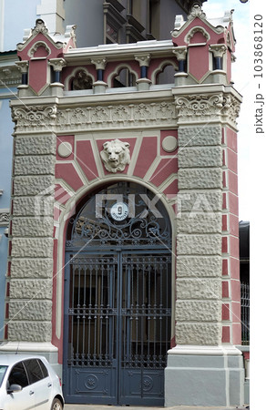 Kiev, Ukraine June 10, 2021: The facade of an ancient building decorated with a plaster lion in the center of Kiev 103868120