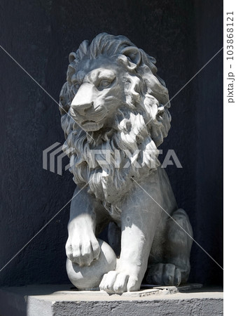Kiev, Ukraine June 10, 2021: The facade of an ancient building decorated with a plaster lion in the center of Kiev 103868121