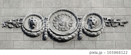 Kiev, Ukraine June 10, 2021: The facade of an ancient building decorated with a plaster lion in the center of Kiev 103868122