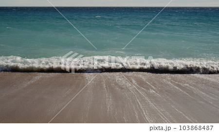 blue waves on a sandy empty beach in Cannes in spring 103868487