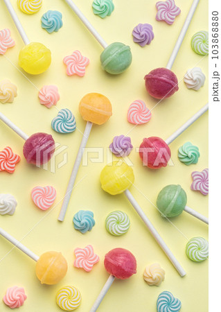 Sweet lollipops and candies on yellow background Sweet lollipops and candies on yellow background 103868880