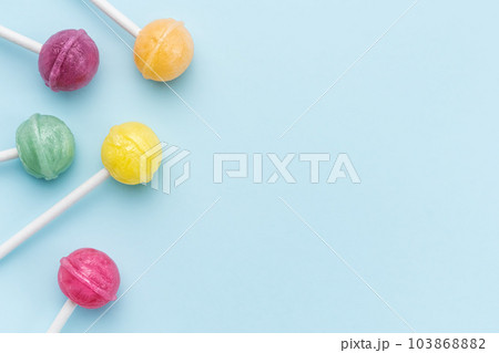 Sweet lollipops on blue background 103868882