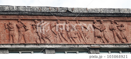 Kiev, Ukraine June 6, 2021: Artistic decoration of the facade of the building with frescoes of the image of people who work and have fun in the city of Kiev 103868921