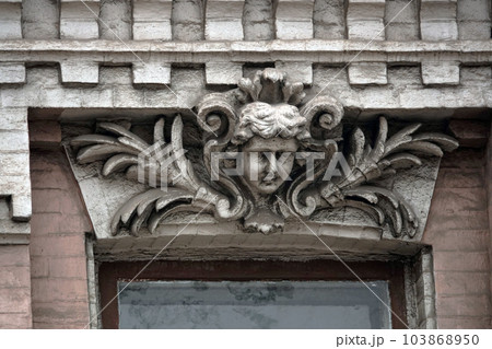 Kiev, Ukraine November 28, 2020: Artistic decor of the facade of the building with a human face in the city of Kiev 103868950