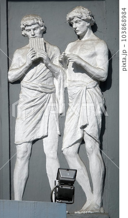 Kiev, Ukraine June 10, 2020: Artistic decoration of the facade of the building with sculptures of people in the city of Kiev 103868984