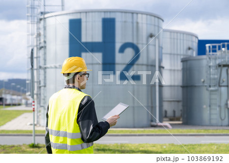 Engineer on a background of Hydrogen factory. 103869192