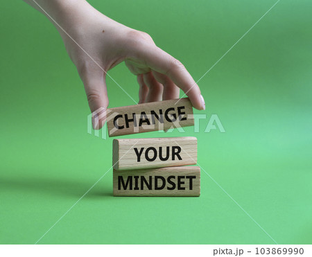 Change your mindset symbol. Concept words Change your mindset on wooden blocks. Beautiful green background. Businessman hand. Business and Change your mindset concept. Copy space. 103869990