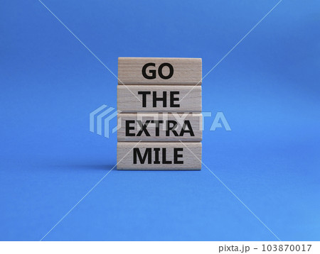 Go the extra mile symbol. Wooden blocks with words Go the extra mile. Beautiful blue background. Business and Go the extra mile concept. Copy space. Go the extra mile symbol. Wooden blocks with words Go the extra mile. Beautiful blue background. Business and Go the extra mile concept. Copy space. 103870017