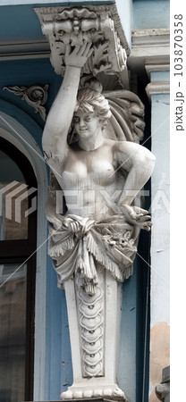 Kiev, Ukraine June 10, 2020: Artistic decoration of the facade of the building with sculptures of people in the city of Kiev Kiev, Ukraine June 10, 2020: Artistic decoration of the facade of the building with sculptures of people in the city of Kiev 103870358