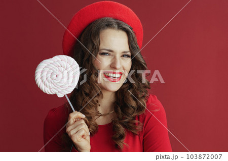 happy elegant female in red dress and beret 103872007