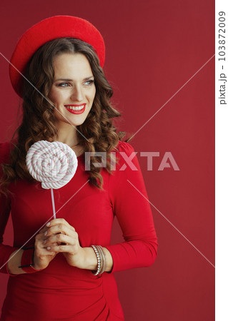 smiling woman in dress and beret isolated on background 103872009