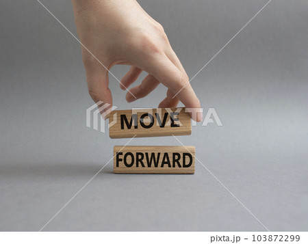 Move forward symbol. Wooden blocks with words Move forward. Beautiful grey background. Businessman hand. Business and Move forward concept. Copy space. 103872299