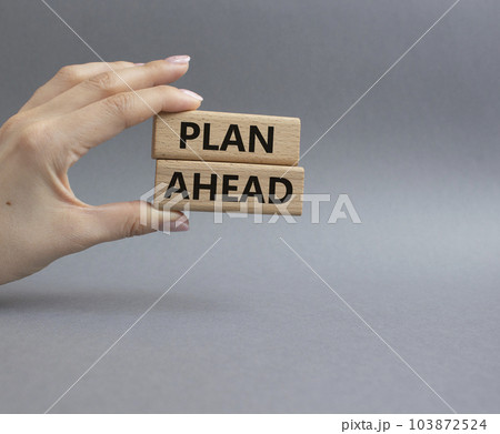 Plan ahead symbol. Wooden blocks with words Plan ahead. Beautiful grey background. Businessman hand. Business and 'Plan ahead' concept. Copy space. 103872524