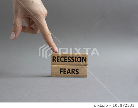 Recession fears symbol. Concept words Recession fears on wooden blocks. Beautiful grey background. Businessman hand. Business and Recession fears concept. Copy space. Recession fears symbol. Concept words Recession fears on wooden blocks. Beautiful grey background. Businessman hand. Business and Recession fears concept. Copy space. 103872533