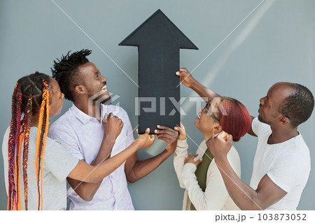 Young african american friends holding black arrow 103873052