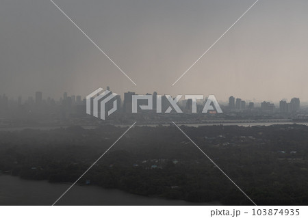 Misty Landscape of city skyscrapers covered before raining. Heavy dense smog fot during afternoon that Bangkok city cannot be seen clearly, Aerial top view of city on a foggy day. 103874935