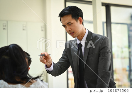 Furious male boss scolding employee with bad work results at group meeting. Emotional pressure, stress at work 103875506