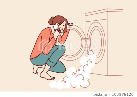 Woman near broken washing machine calls home electronics repairman because of foam pouring out drum 103876120