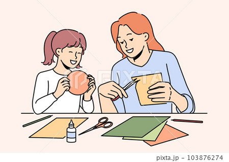 Smiling mother and daughter enjoy arts and crafts  103876274