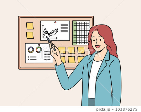 Businesswoman demonstrates financial graphs and charts pinned on cork board in office 103876275