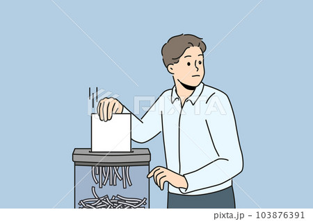 Businessman put document in shredder  103876391