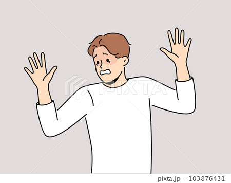 Frightened man raises hands in surrender and demonstrates obedience and refusal to resist Frightened man raises hands in surrender and demonstrates obedience and refusal to resist 103876431