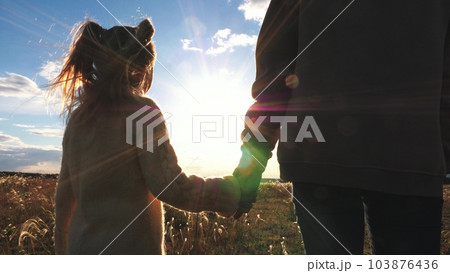 friendly family emotions sunset, happy child holding hand loving father mother, happy child holding hand, helping hand child parent, daughter mom walk sunset sky park friendly family emotions sunset, happy child holding hand loving father mother, happy child holding hand, helping hand child parent, daughter mom walk sunset sky park 103876436