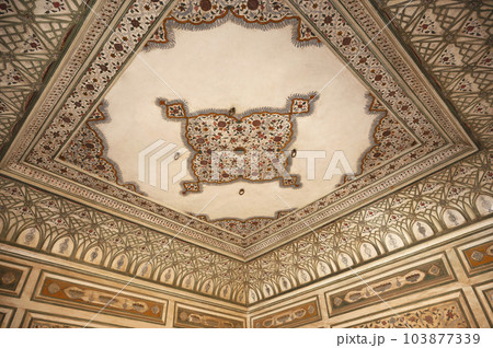 Colourful painting on the inner wall of Hawa Mahal or Wind Palace, built from red and pink sandstone. It is akin to a honeycomb with its 953 small windows called Jharokhas decorated with intricate 103877339