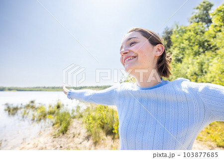 Free Happy Woman Enjoying Nature on a forest lake. Beauty Girl Outdoor. Freedom concept. Beautiful 103877685