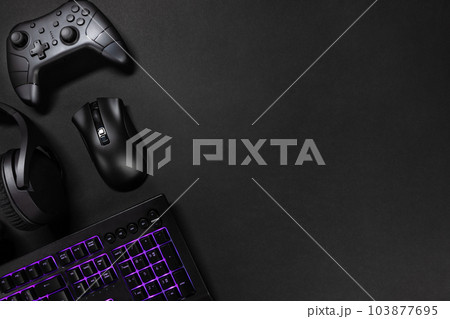 Purple lit keyboard by game controller and mouse Purple lit keyboard by game controller and mouse 103877695